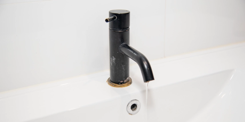 Leaking Taps Close-up of a leaking bathroom tap in need of repair.