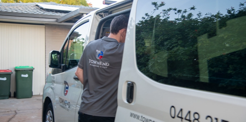 Ashley Townend owner operator of Townend Plumbing & Gas, unloading equipment from his service van.