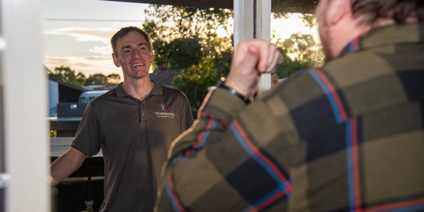 Ashley Townend greeting a customer at their front door